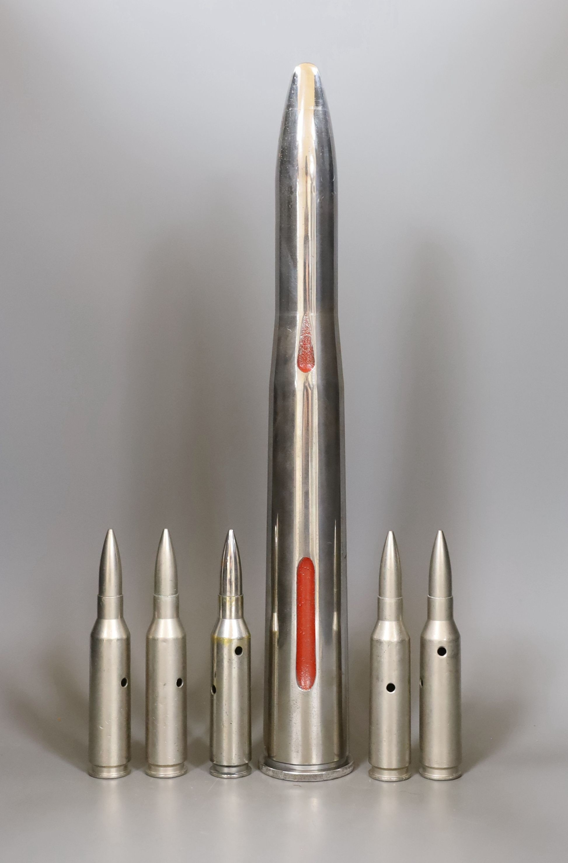 Polished steel military training round and five 50 calibre rounds